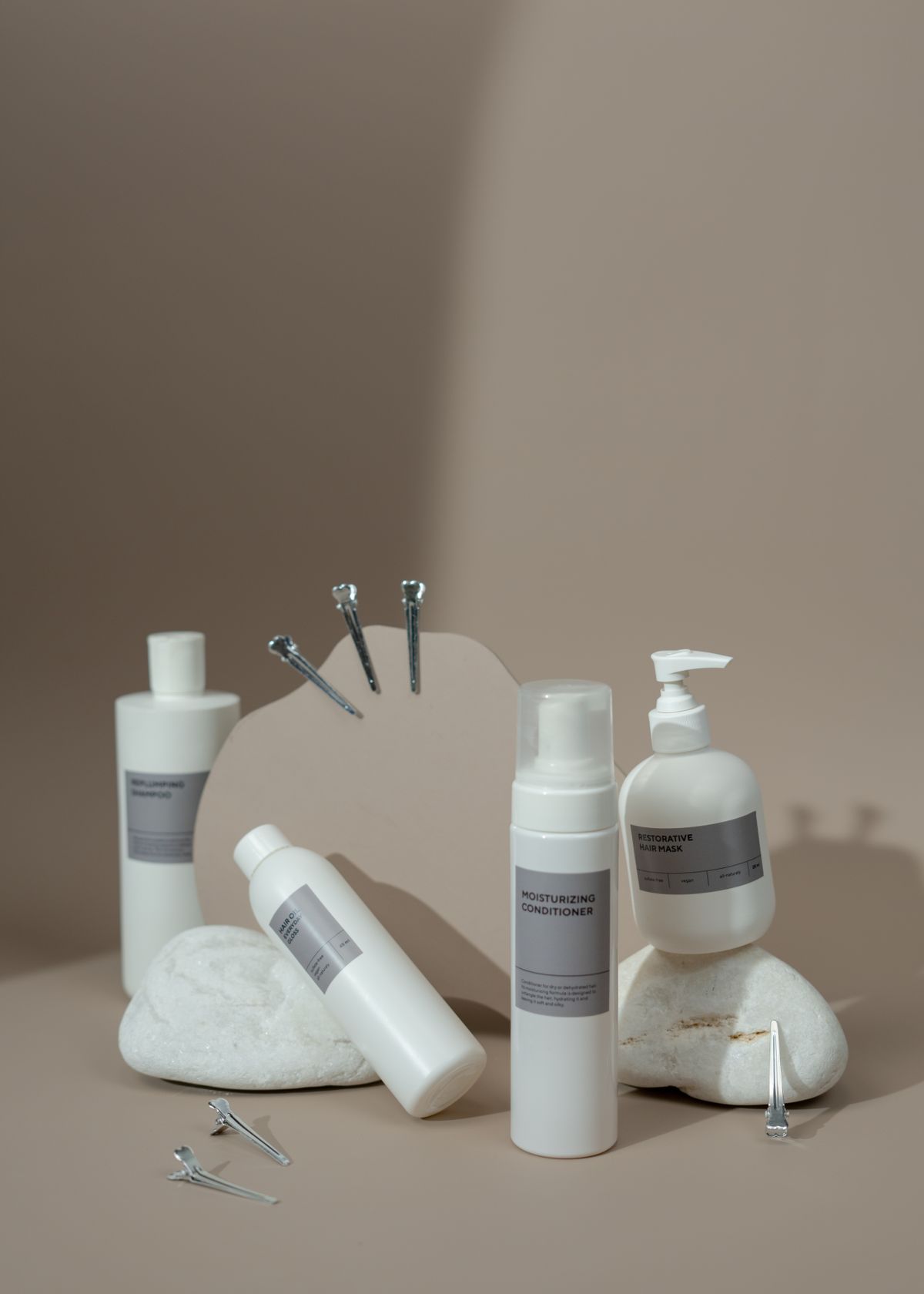 White skincare products on stone and a warm background
