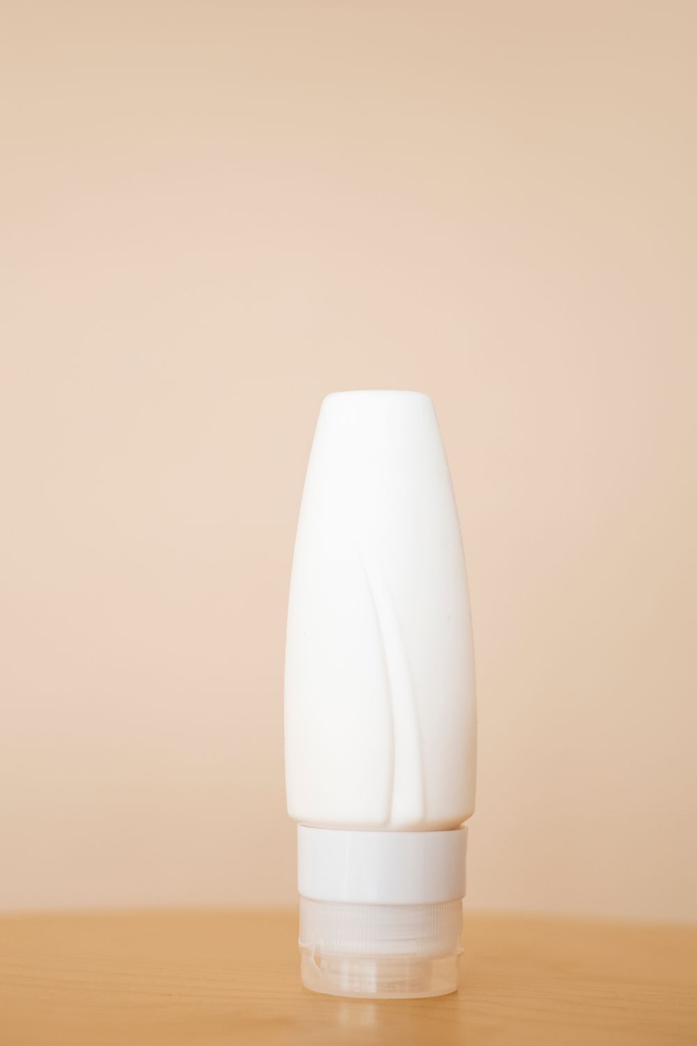 White skincare tube on a warm background